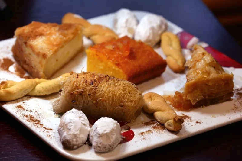 Assorted Greek desserts including baklava and kataifi